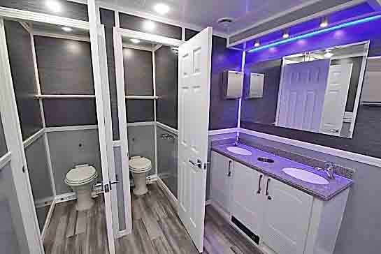 Celebrity FS 810 portable restroom trailer for sale with blue accent lighting